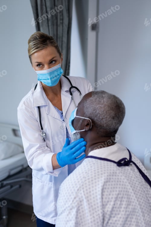 Preview: Caucasian female doctor wearing face mask palpating lymph nodes of african american male patient