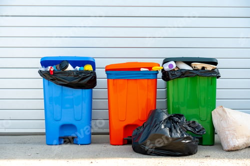 Preview: Three trash containers full of garbage near the building
