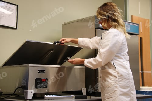 Preview: Medical worker performing temperature Quality check on water bath.