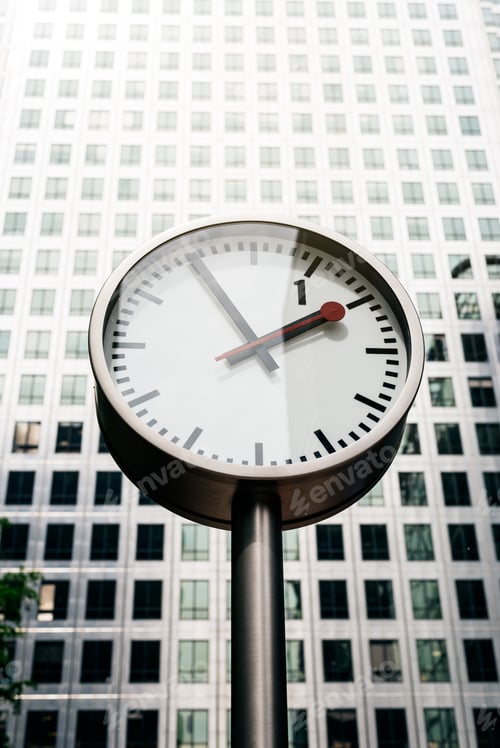 Preview: Street clock with tall building on the background