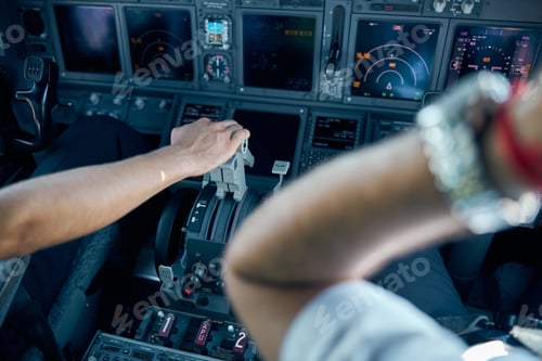 Preview: Captain hand on controlling dashboard in the cockpit of aircraft