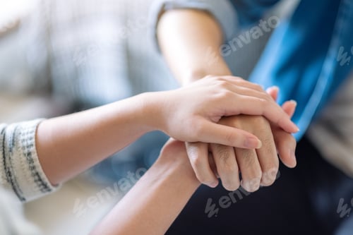 Preview: A man and a woman holding each other hands for comfort and sympathy