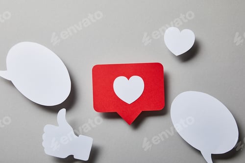 Preview: red like card, speech bubbles, thumbs up and small paper heart on white surface