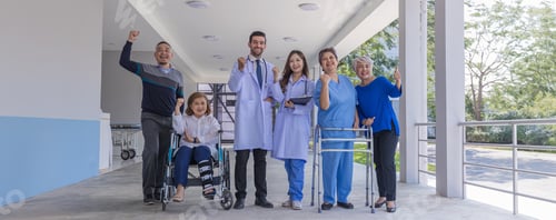 Preview: Doctors and nurse in hospital corridor with senior female and senior male patient in walker