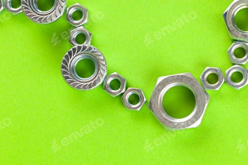 Preview: Tools. Nuts on green background close up