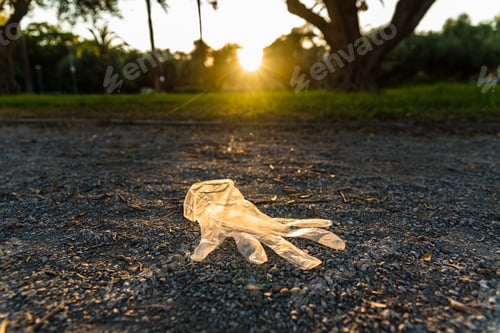 Preview: Plastic gloves from a supermarket abandoned on the ground in a park, polluting.