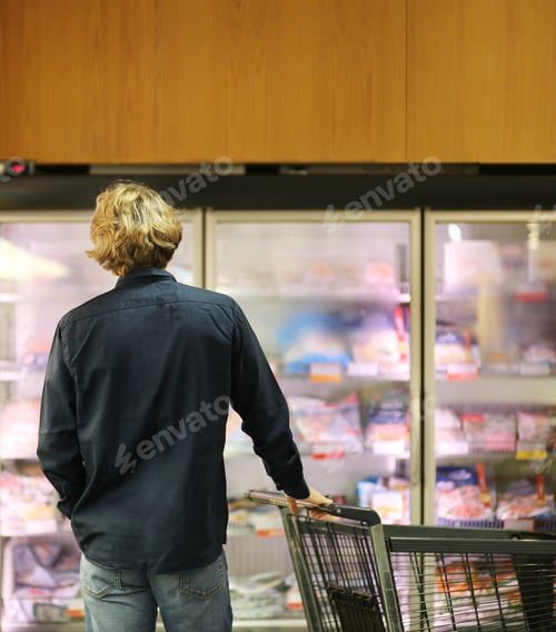 Preview: Man Choosing Frozen Food From A Supermarket Freezer