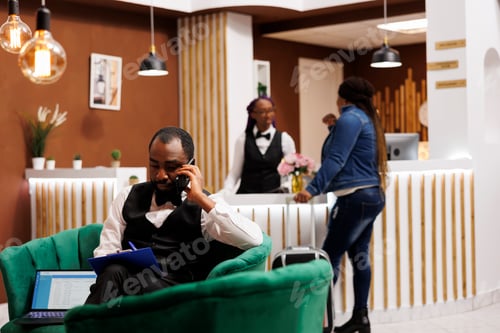 Preview: Hotel bellboy calling taxi for guest