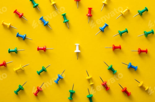 Preview: White push pin in the center of color push pins with their spike turned to the white one