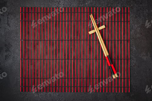 Preview: Japanese table setting. Bamboo chopsticks and mat in red black colors