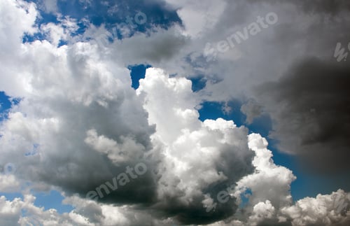 Preview: Amazing sky with puffy white and grey clouds.