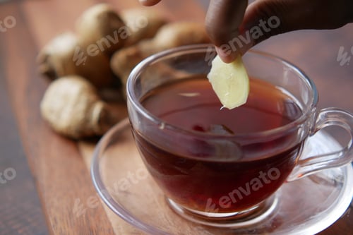 Preview: Top view of ginger tea on wooden background.
