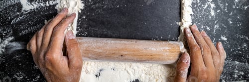 Preview: Female hands keep rolling pin with flour on dark table. Baking background