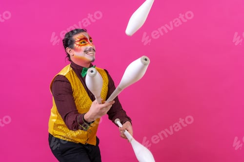 Preview: Clown with white facial makeup on a pink background, juggling maces