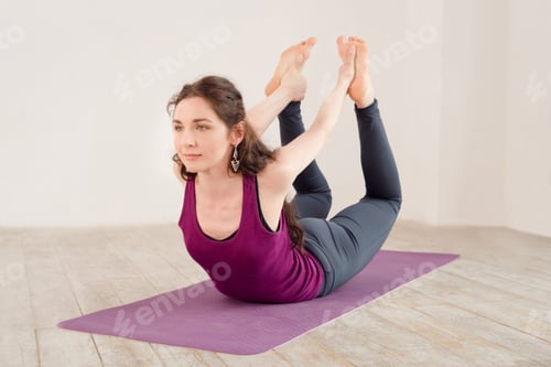 Preview: Young woman doing yoga exercises