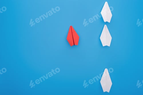 Preview: Flat lay with white and red paper planes on blue