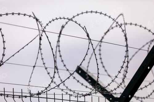 Preview: Barbed wire on the sky background. selective focus. metal wire