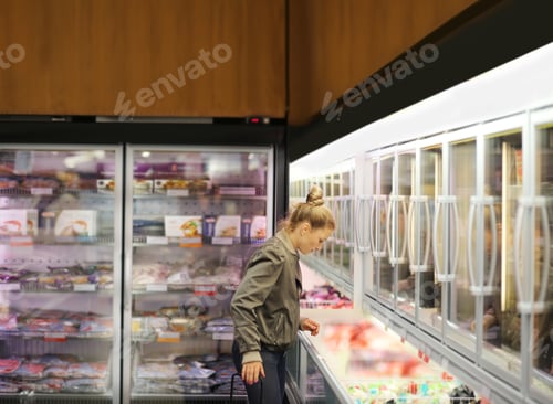 Preview: Woman Choosing Frozen Food From A Supermarket Freezer