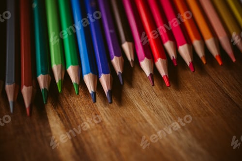 Preview: Colored pencils on wooden background with selective focus. Back to school and education concept.