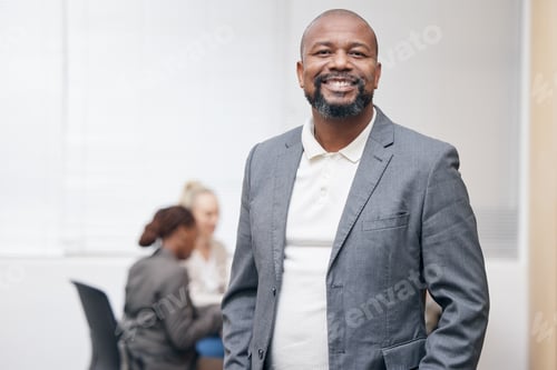 Preview: Portrait of a confident mature businessman standing in an office