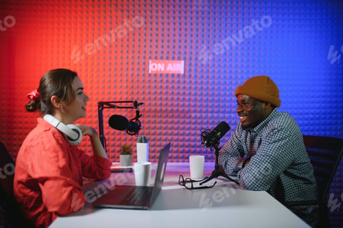 Preview: Man and woman livestreaming online discussion on podcast episode