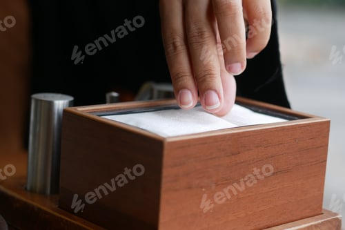 Preview: hand pull out a piece of tissue from tissue paper box