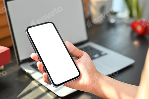 Preview: Woman hand holding mobile phone with white blank display, empty screen for graphic display montage.