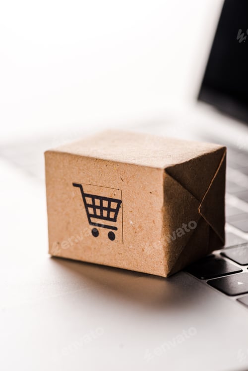 Preview: close up of toy box on laptop keyboard isolated on white, e-commerce concept