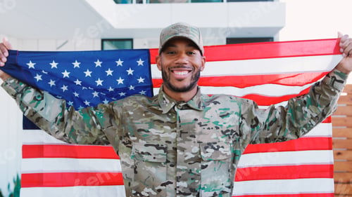 Preview: Portrait Of Male Soldier In Uniform Visiting Home On Leave Holding Stars And Stripes Flag