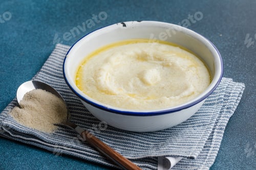 Preview: Semolina porridge in a vintage bowle for a breakfast on blue table