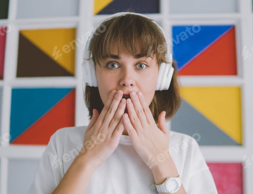 Preview: Surprised Woman Listening with Headphones Covers Mouth