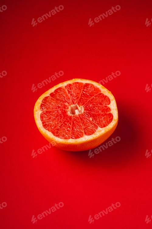 Preview: Sliced grapefruit on vibrant red background