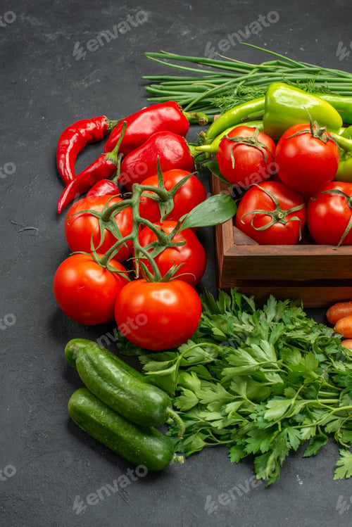Preview: Vertical view of vegetable basket with a bunch of green and peppers cucumber and tomatoes with stem