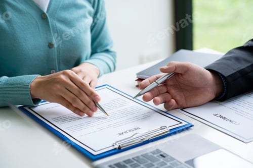 Preview: Human resources manager conducting job interview with applicant in the office, Candidate with resume