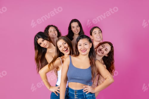 Preview: Smiling Women Grouped Together Against a Pink Background