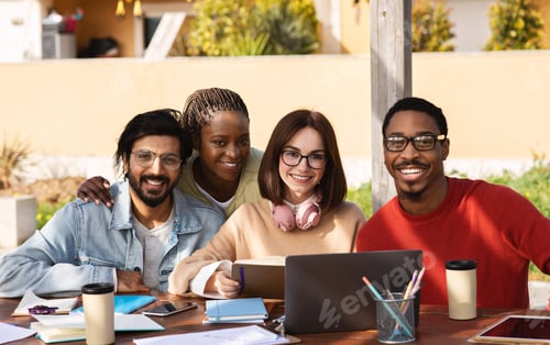 Preview: Happy millennial different people students studying with laptop together, working on project