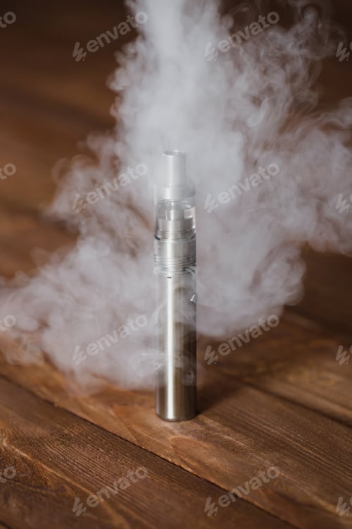 Preview: Electronic cigarette on a wooden table. Smoke