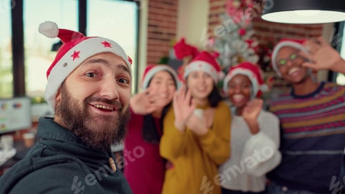 Preview: Diverse people taking photos near christmas tree in office
