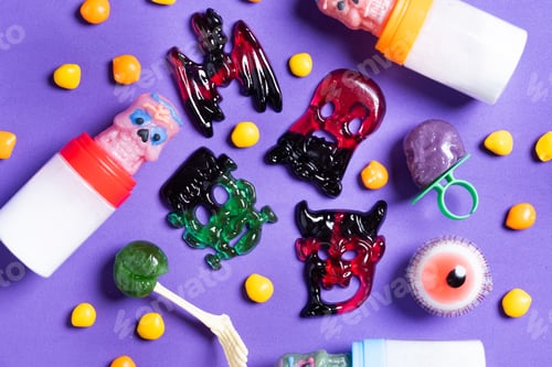 Preview: Assortmen of Halloween candies on colorful background