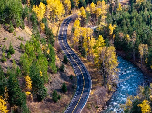 Preview: Winding Mountain Road Through Golden Fall Forest Beside a Rushing River in British Columbia
