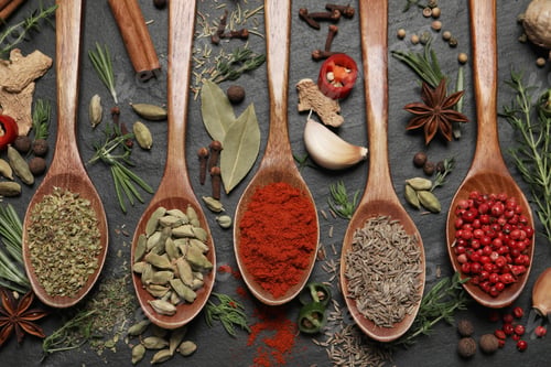 Preview: Flat lay composition with different natural spices and herbs on black table
