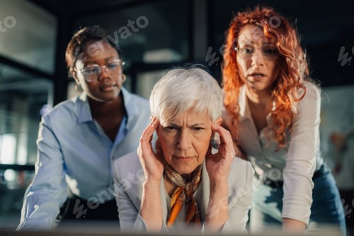 Preview: Serious senior boss looking at poorly done report with interracial team