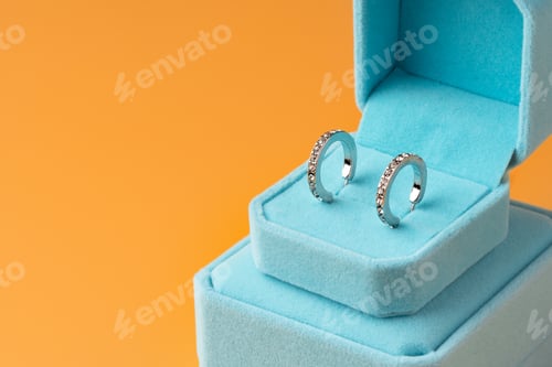 Preview: Blue jewelry box on yellow background close up