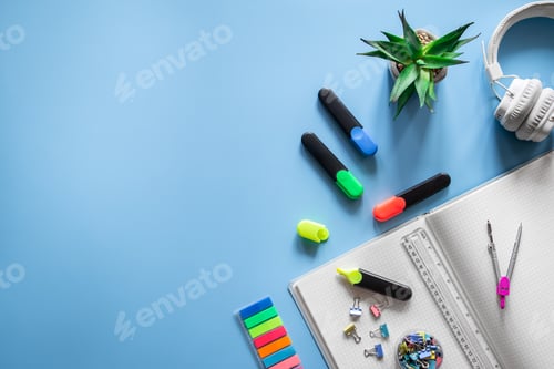 Preview: School supplies stationery on a blue background, copy space.