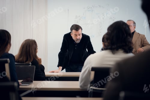 Preview: Portrait of a senior businessman giving a presentation to his colleague at office