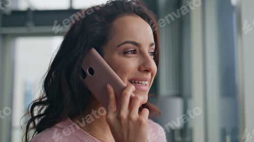 Preview: Smiling woman talking mobile phone at home closeup. Relaxed girl looking window