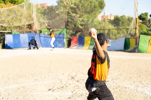Preview: Young boy pitching baseball during youth league game
