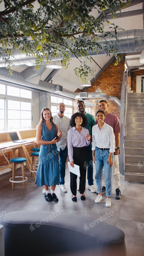 Preview: Portrait Of Multi-Cultural Business Team Standing In Modern Open Plan Office Together