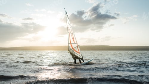 Preview: Morning windsurfing on the lake sunrise,