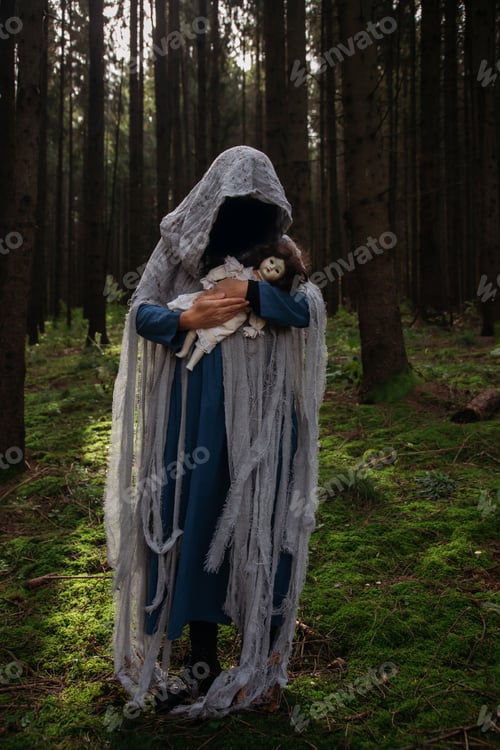 Preview: Horror background of a ghostly figure in enchanted a forest on a moody autumn day.